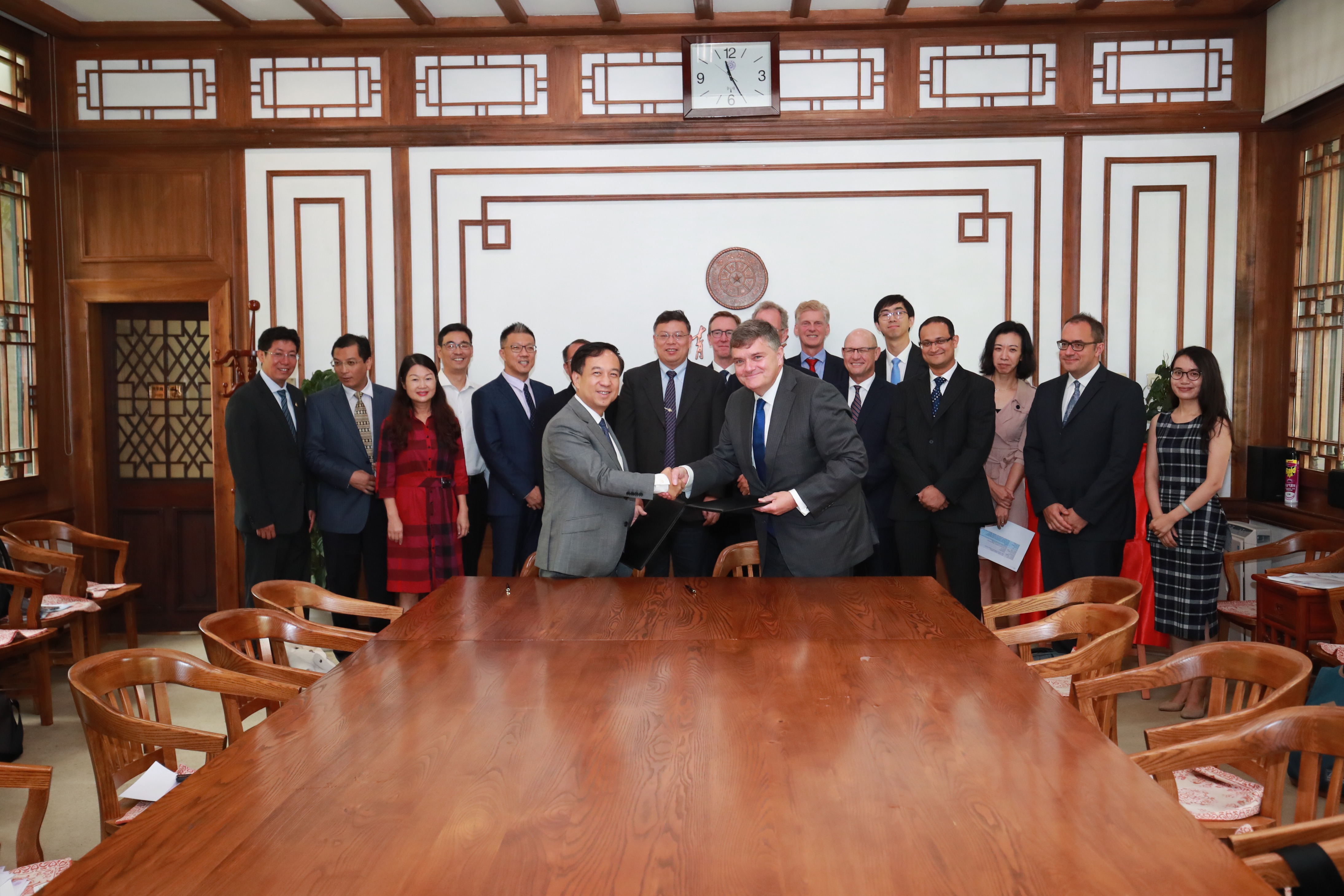 Clive R. Wood, Boehringer Ingelheim and Chen Dong, Tsinghua University shaking hands at signing ceremony in Beijing